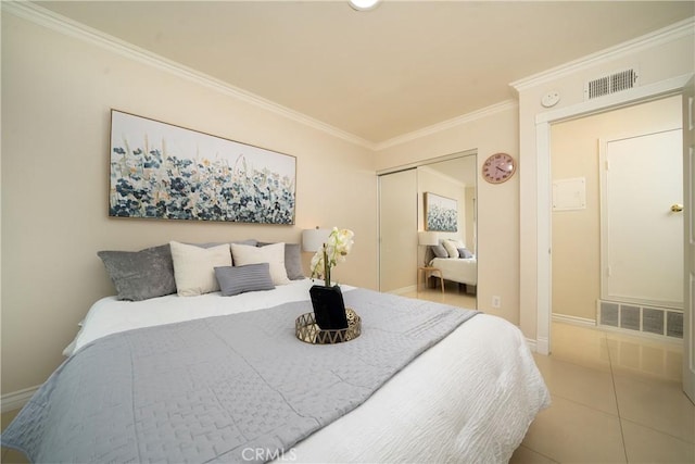 tiled bedroom with ornamental molding and a closet