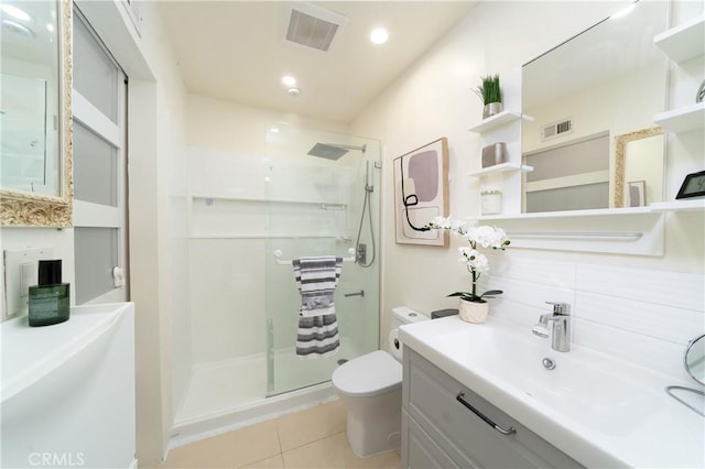 bathroom featuring vanity, toilet, tile patterned flooring, and a shower with door