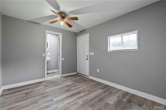 spare room with light hardwood / wood-style floors and ceiling fan