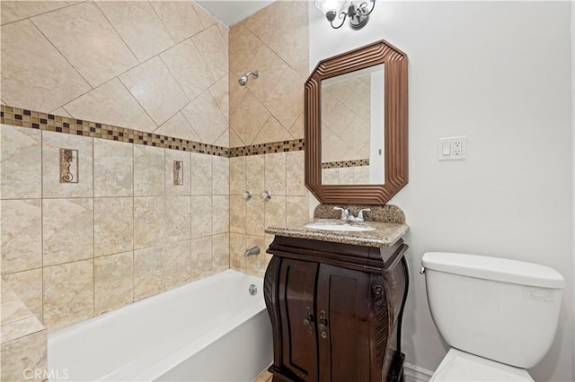 full bathroom with vanity, tiled shower / bath, and toilet