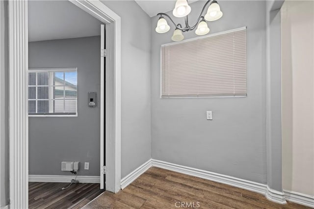 interior space with an inviting chandelier and wood-type flooring