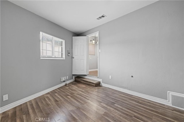 empty room featuring wood-type flooring