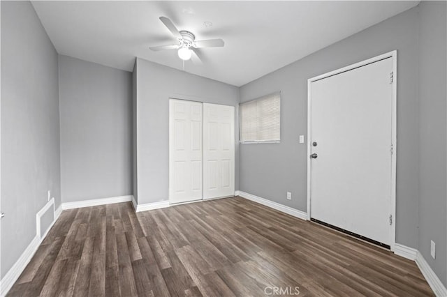 unfurnished bedroom featuring dark hardwood / wood-style flooring and ceiling fan