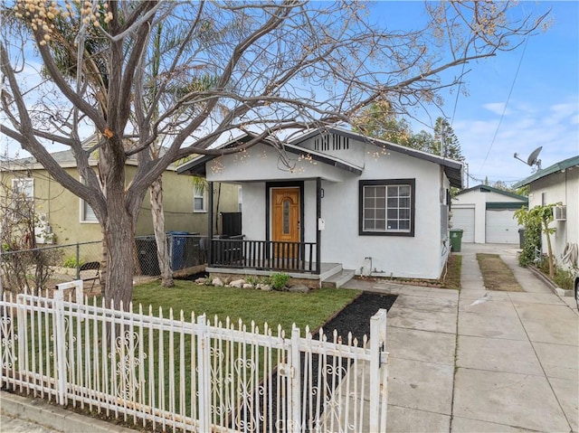 bungalow-style home featuring an outbuilding, a garage, and a front lawn