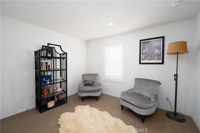 sitting room featuring light colored carpet