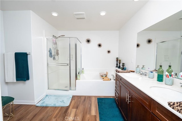 bathroom with hardwood / wood-style flooring, vanity, and separate shower and tub