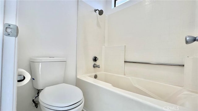 bathroom featuring shower / washtub combination and toilet