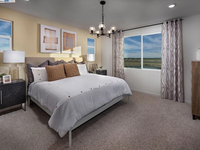 carpeted bedroom featuring a chandelier