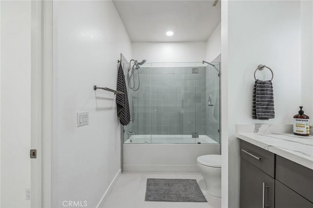 bathroom with toilet, combined bath / shower with glass door, vanity, baseboards, and tile patterned floors