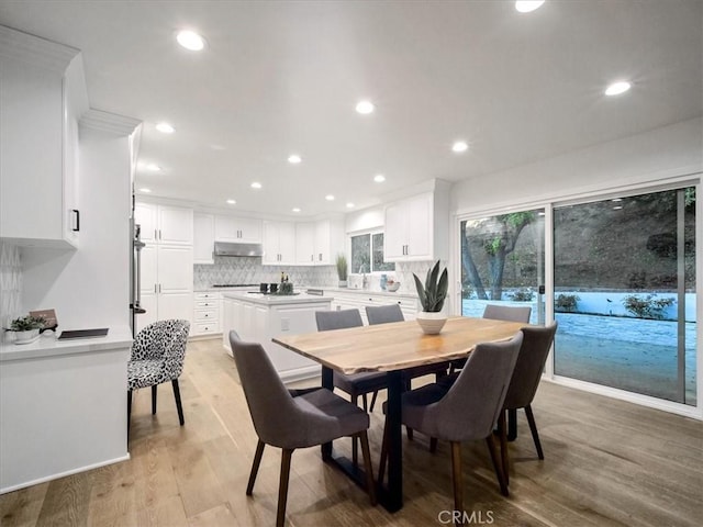 dining room featuring sink and light wood-type flooring