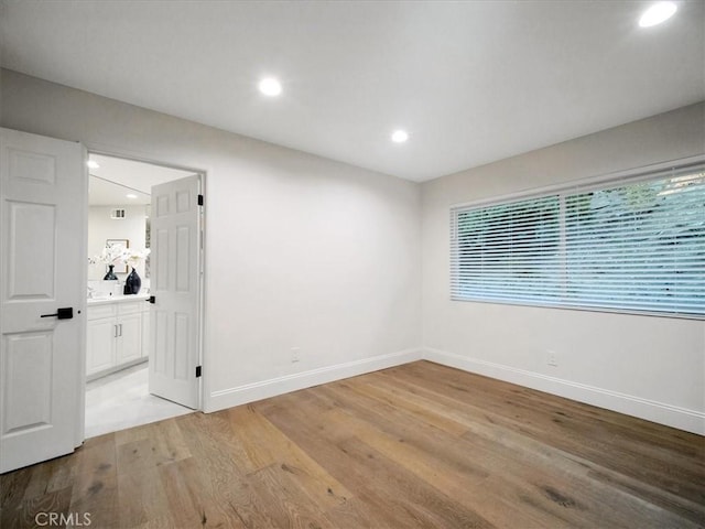 spare room featuring light hardwood / wood-style floors