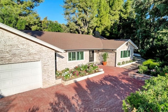 ranch-style home featuring a garage