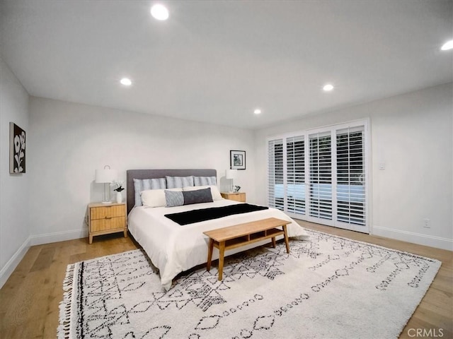 bedroom with access to exterior and light wood-type flooring