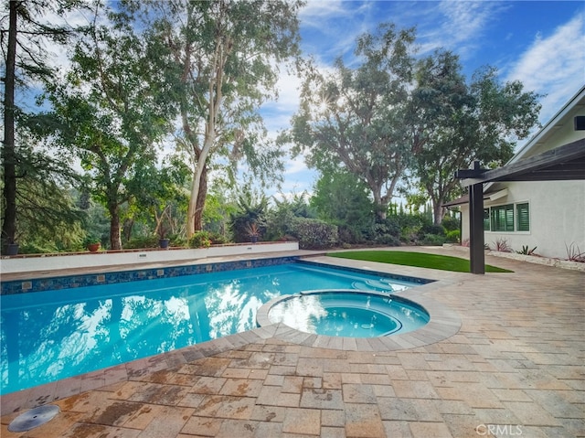 view of pool featuring an in ground hot tub and a patio area