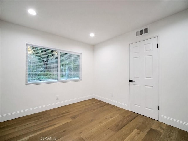 unfurnished room with hardwood / wood-style floors