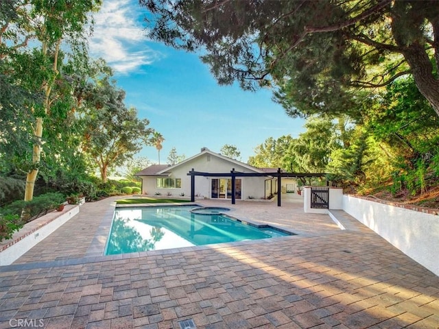 view of pool with an in ground hot tub, a pergola, and a patio area