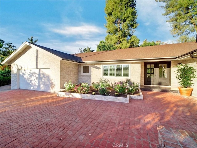 single story home featuring a garage