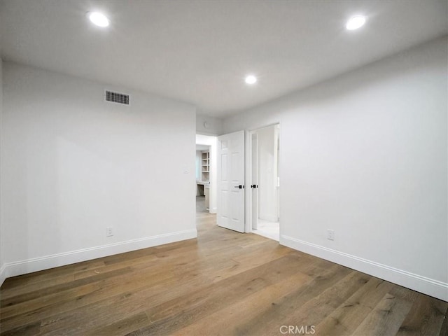 unfurnished room with hardwood / wood-style floors