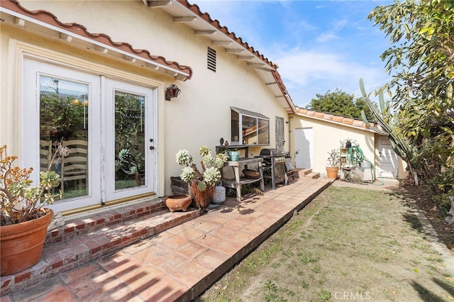 view of home's exterior with a patio and french doors