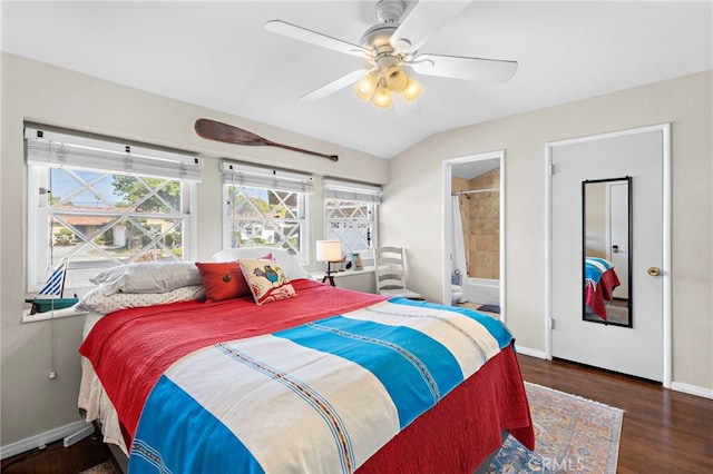 bedroom with lofted ceiling, dark wood-type flooring, connected bathroom, and ceiling fan