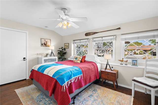 bedroom featuring ceiling fan, lofted ceiling, and dark hardwood / wood-style flooring