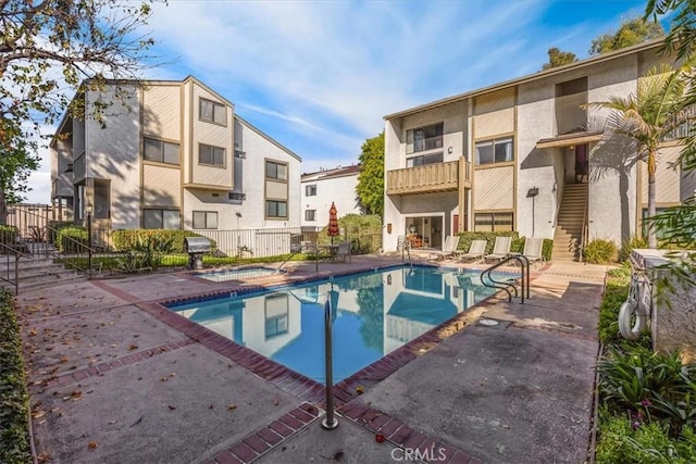 view of swimming pool featuring grilling area and a patio area