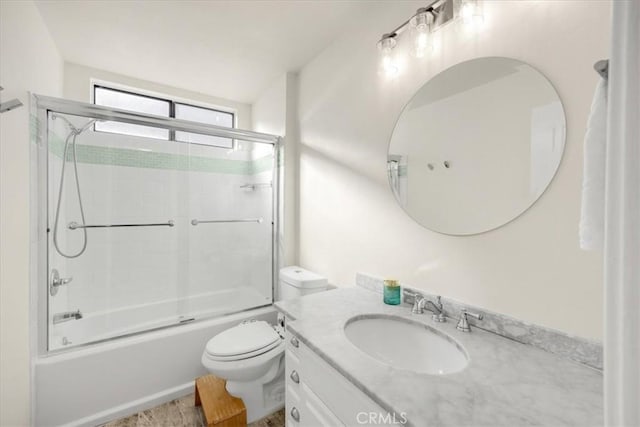 full bathroom with vanity, shower / bath combination with glass door, and toilet