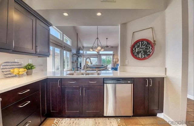 kitchen with hanging light fixtures, a wealth of natural light, sink, and stainless steel dishwasher