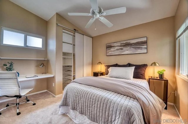 bedroom featuring light carpet, vaulted ceiling, and ceiling fan