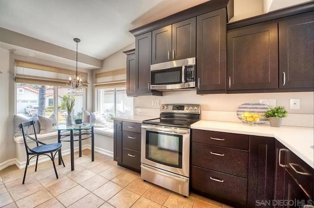 kitchen featuring lofted ceiling, an inviting chandelier, hanging light fixtures, dark brown cabinets, and appliances with stainless steel finishes