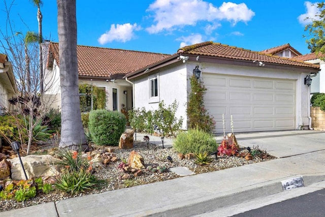 mediterranean / spanish-style house with a garage