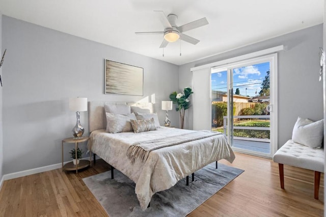 bedroom with hardwood / wood-style flooring, access to outside, and ceiling fan