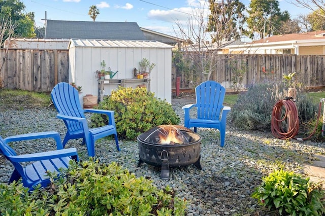 view of patio featuring a shed and a fire pit