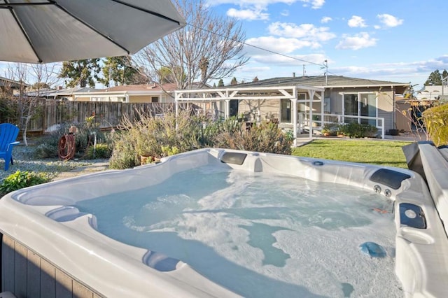 view of swimming pool featuring a hot tub and a lawn