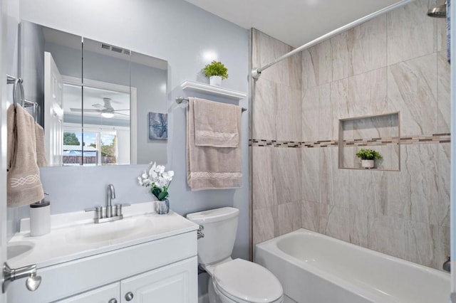 full bathroom with tiled shower / bath combo, vanity, and toilet