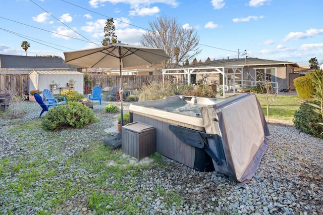 view of yard featuring a storage shed and a hot tub