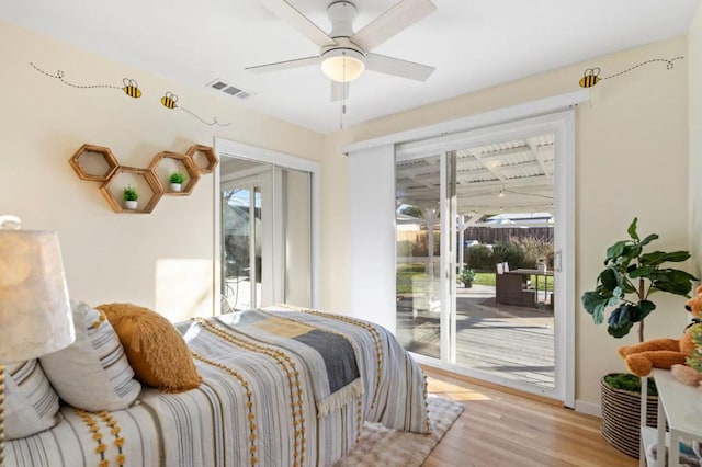 bedroom with multiple windows, access to exterior, ceiling fan, and light hardwood / wood-style flooring