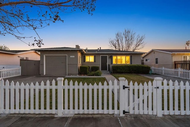 ranch-style house featuring a yard and a garage