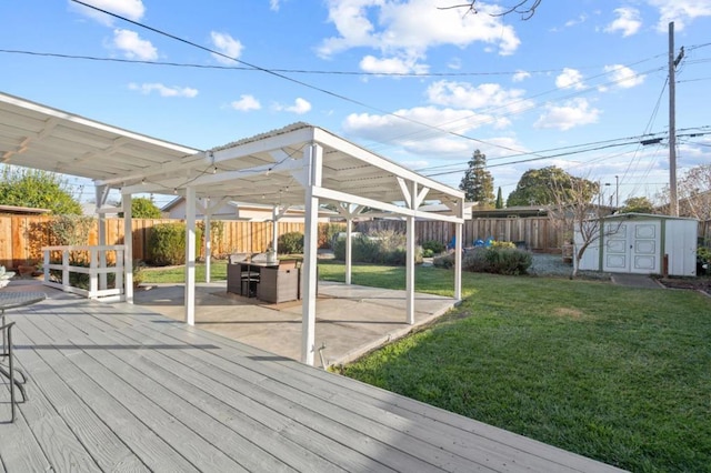 wooden deck featuring a yard, a patio area, and a storage shed