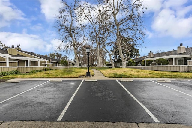 view of vehicle parking with a yard