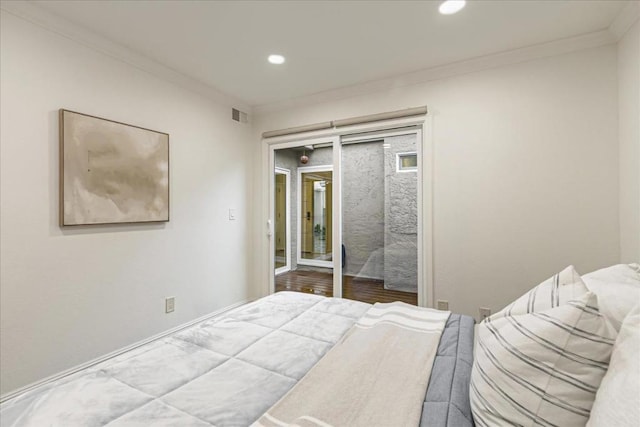 bedroom with ornamental molding, access to exterior, and hardwood / wood-style floors