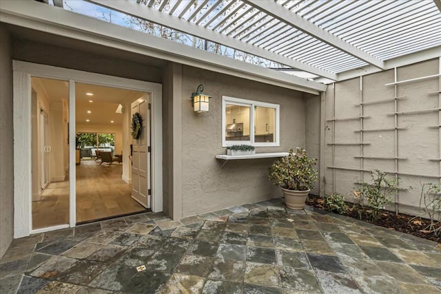 doorway to property featuring a pergola and a patio area