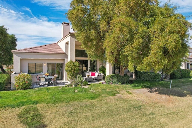 back of property featuring a patio, outdoor lounge area, and a lawn