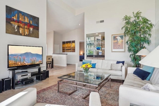 living room featuring tile patterned flooring and high vaulted ceiling