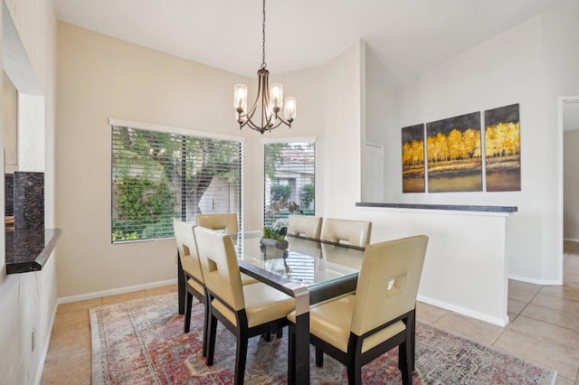 dining area featuring an inviting chandelier, light tile patterned floors, and vaulted ceiling