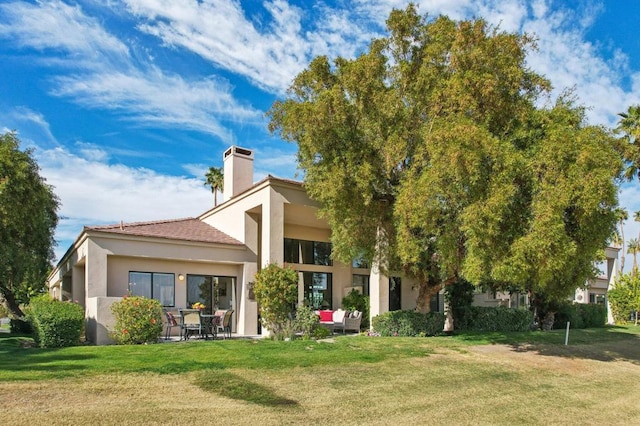 rear view of property featuring a yard