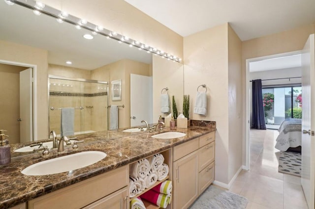 bathroom featuring tile patterned floors, vanity, and an enclosed shower