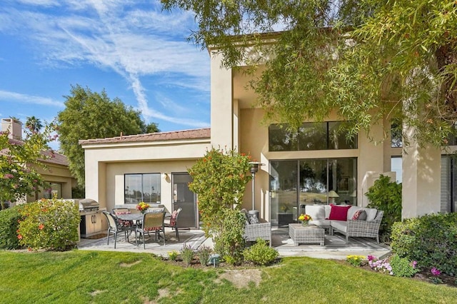 rear view of house with a yard, outdoor lounge area, and a patio area