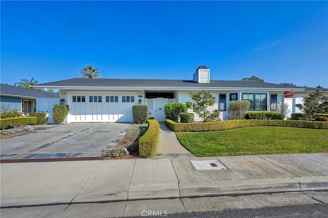 ranch-style home with a garage and a front lawn