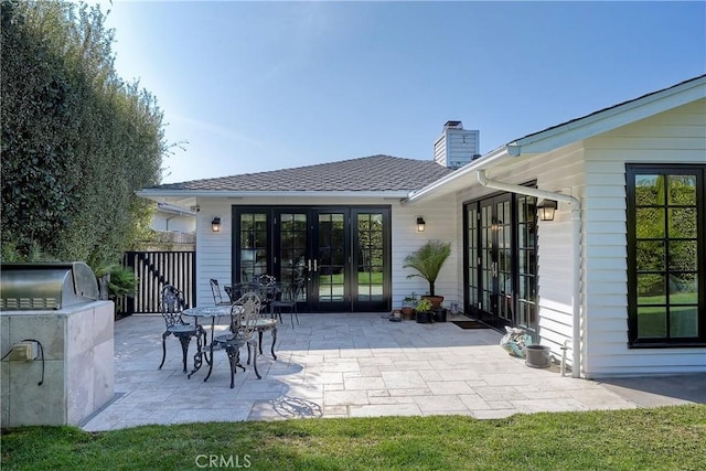 rear view of house with french doors and a patio